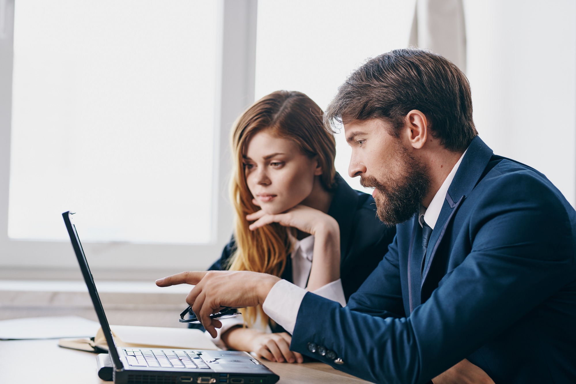 business man and woman watching a laptop