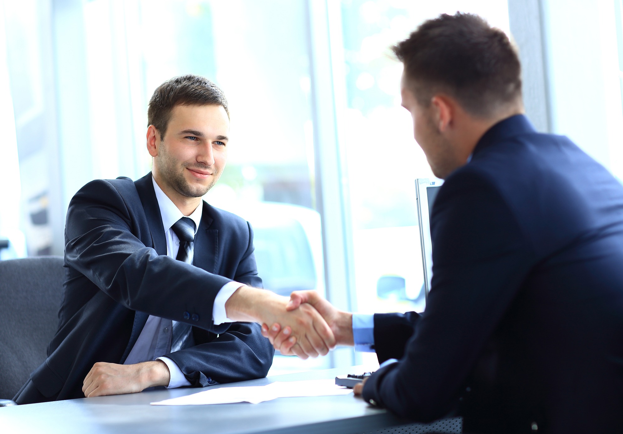 businessman shaking hands to seal a deal with his partner; Shutterstock ID 149002709; Purchase Order: Limited 12/22/2020
